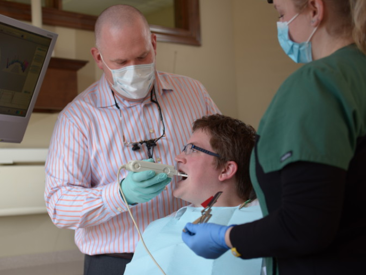 a man is having his mouth examined using our dental technology