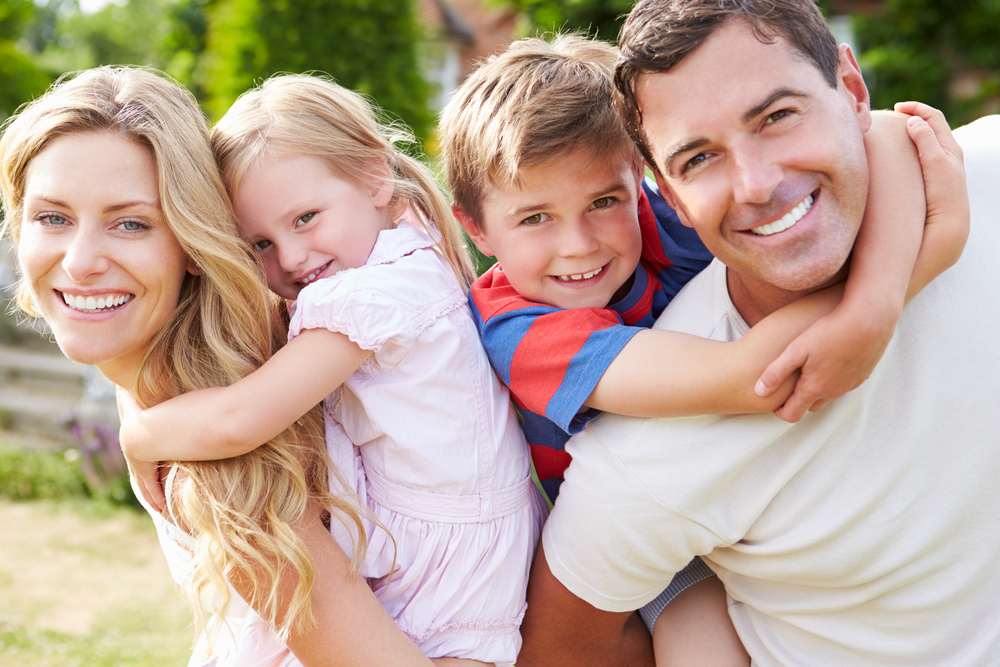 A family is proud to have cavity-free teeth thanks to tooth-colored fillings and family dentistry