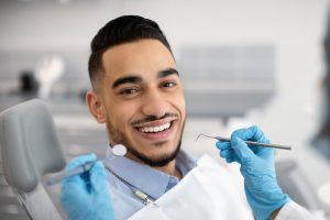 young man smiling in dental chair