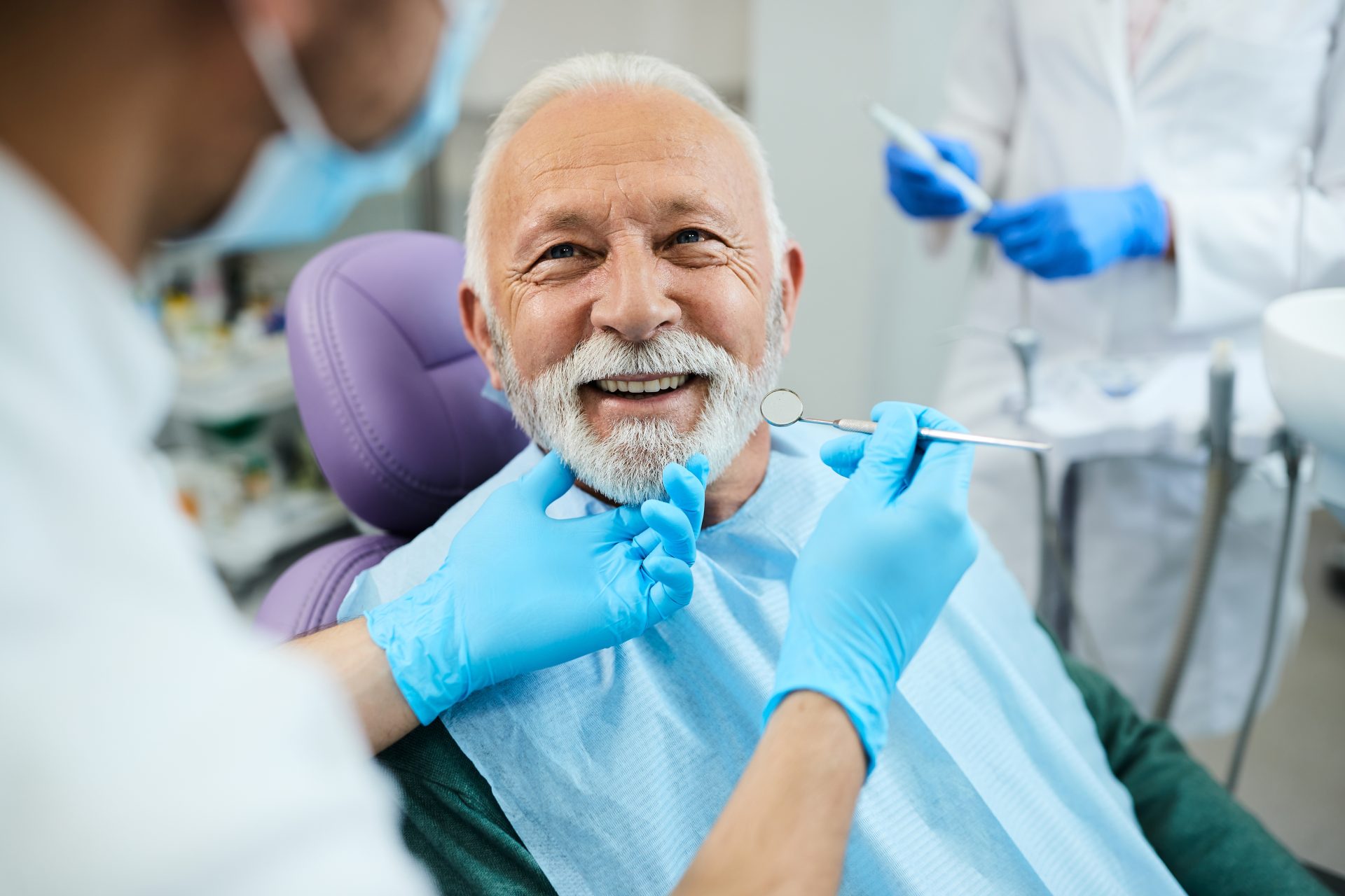 smiling man in a dental chair during a check-up
