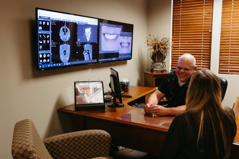 Dr. Yenchesky puts on a friendly, caring smile during a patient consultation.