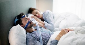 cpap sleep apnea mask on sleeping man
